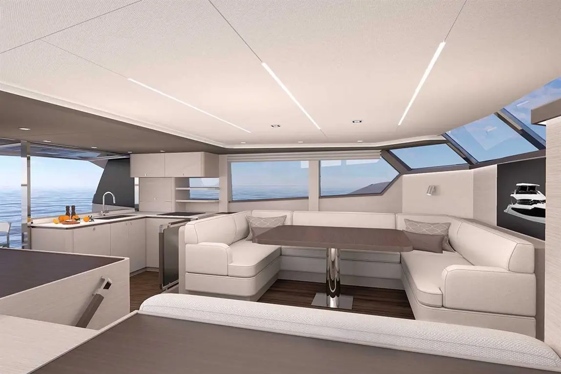 Modern yacht interior featuring a spacious lounge area, kitchen with fruit, and large windows overlooking the sea.